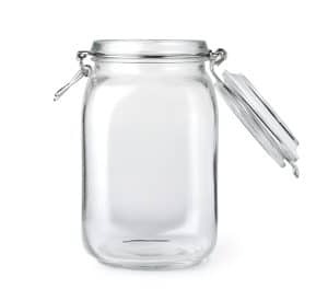 Opened empty glass jar isolated on a white background
