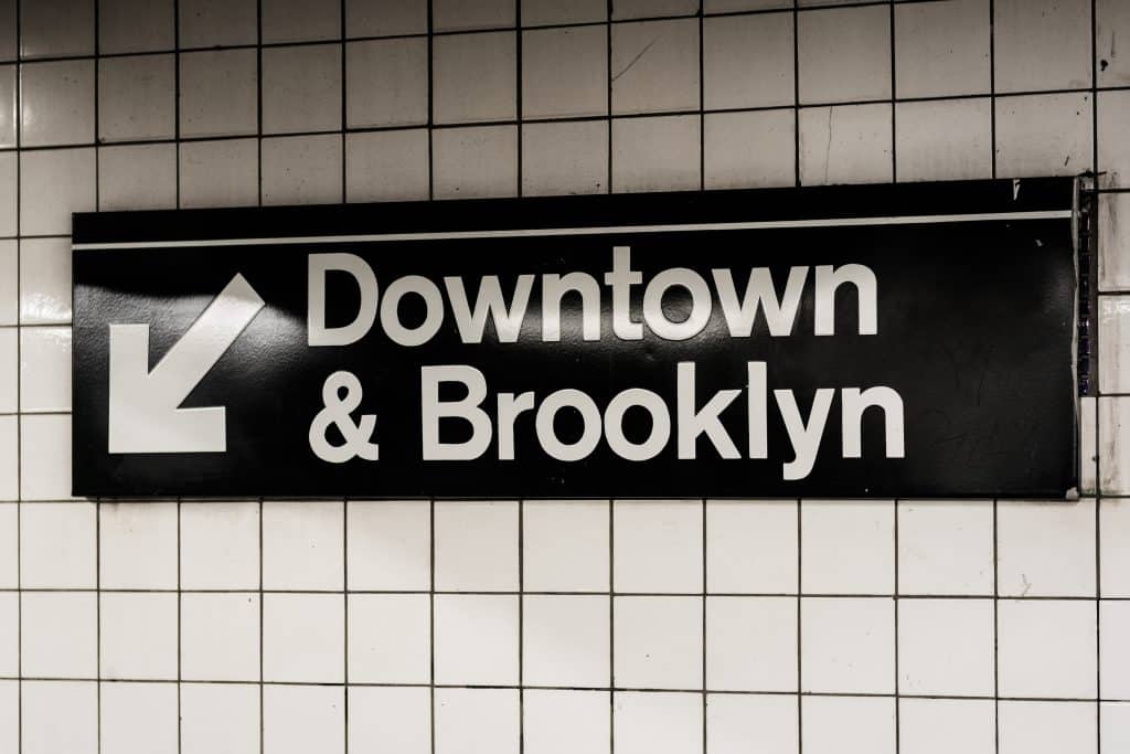 Downtown & Brooklyn sign in a subway station in Manhattan, New York City.